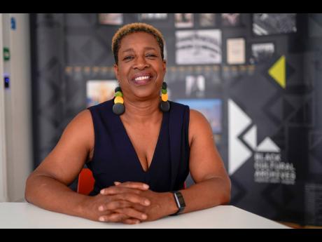 Evadney Campbell poses for a photograph, following an interview with The Associated Press at the Black Cultural Archives, in London, Wednesday, June 21, 2023. 