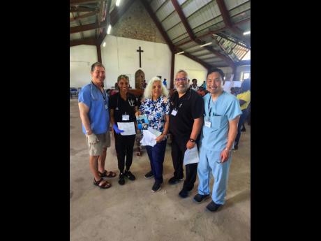 Joan Crawford (centre), president of AOJAH and members of her medical staff inside the St George’s Anglican Church, where they provided medical assistance to residents of Blackstonedge and surrounding areas.