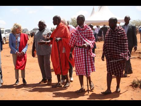 US first Lady Jill Biden (left) greets members of the Maasai community as they explain the drought situation in Ngatataek, Kajiado Central, Kenya, in this February 26, 2023, photo. 
