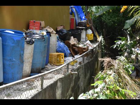 Garbage like this seen behind a business establishment in a St James Central community could end up in the drains.