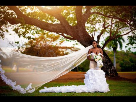 The beautiful bride with her stunning veil in flight said yes to this exquisite dress from Cochen Bridal.