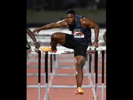 Former World Under-18 champion, De’Jour Russell clears a hurdle on his way to winning the 110-metre hurdles event at the JAAA Quest for Budapest series track meet at the Jamaica College Ashenheim Stadium on Saturday.