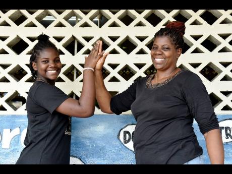 Monica Rodney-Young (right) celebrates with her daughter, Tasheka Young, who placed among the top two students in the Primary Exit Profile examination results for Savanna-la-Mar Primary School, and who has been awarded a place at The Manning’s School.