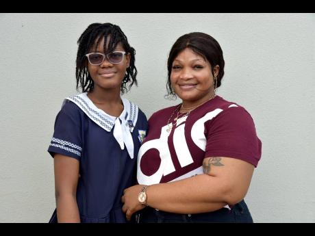 De-Asia Thomas is hugged by her mother Samaya-Gay Wallace for landing her school of choice, The Manning’s School, and for being among Savanna-la-Mar Primary School’s top two performers in this year’s Primary Exit Profile examinations. 