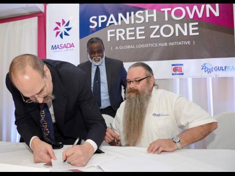 
In this October 28, 2015 Gleaner photo, Executive Director of Masada Jamaica Dr Bob Melamede (left) signs the agreement for the Spanish Town Free Zone, while Chairman of Jamaica’s Logistics Hub Task Force Dr Eric Deans (centre) and Managing Director of 