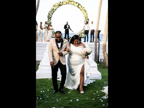 Officially husband and wife, Andre and Sherika take that first walk into forever together. 