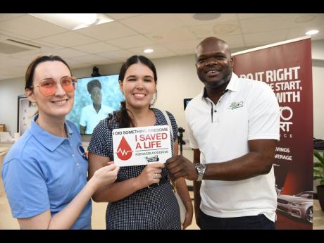 Embassy of Cuba in Jamaica diplomat and proud blood donor, Anabel Landron Ochoa (centre), is flanked by Musson Foundation Chairperson Melanie Subratie, and GenAc Executive Director Gregory S. Foster at the General Accident blood drive held on June 16 at 58
