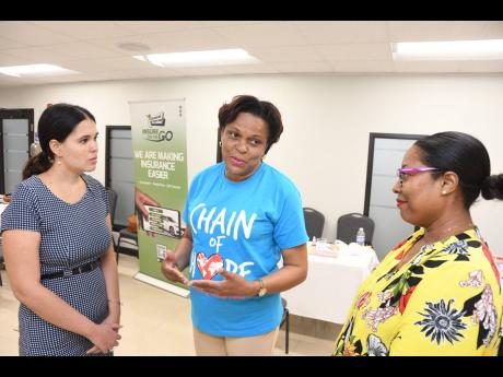 With the collection target of 30 units of blood met at the mid-way mark of the GenAc blood drive, the manager of fundraising and operations at Chain of Hope, Nola Phillpotts Brown (centre), explains the impact with Embassy of Cuba in Jamaica diplomat Anabe