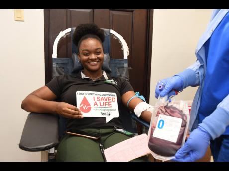 Data entry clerk at GenAc Kadian Grant beams with pride as she made her life-saving donation at the third annual General Accident blood drive on June 16. 