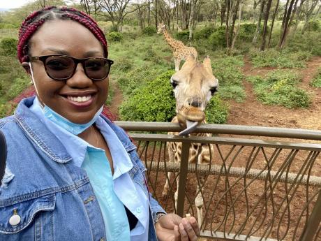 Thomas happily feeding a giraffe at the Giraffe Center located in Nairobi, Kenya