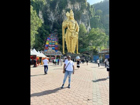 The calm before the walking storm. Her heart was at a normal resting rate standing in front of the statue of Murugan, before she began climbing the 272 steps to head into the Batu Caves in Malaysia.