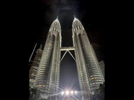 Seeing the Petronas Twin Towers, the largest twin towers in the world and headquarters of the national petroleum company: sponsors of F1 Grand Prix, in Malaysia at night, was a beauty to behold.