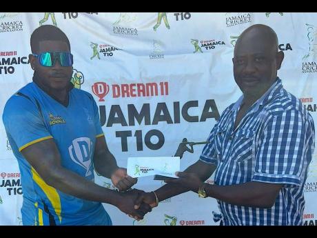 Surrey Royals opener Leroy Lugg accepts his Player of the Match award from Jamaica Cricket Association second vice president Frtiz Harris after yesterday’s Dream XI-sponsored T10 round 13 clash at Kensington Park. The Surrey Royals defeated the Surrey Ki