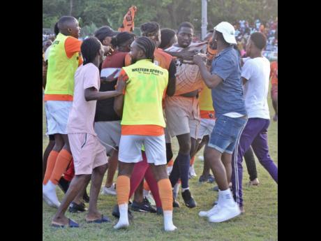 
Lime Hall Community Club’s goalkeeper Oshane Allen (third from right)  is mobbed by teammates and supporters after the Jamaica Football Federation National Tier II second-leg semifinal game at Drax Hall last Sunday. 