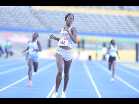 University of Texas' Dejanea Oakley strolls to the under-20 800-metre national title at the JAAA/PUMA National Senior and Junior Championships inside the National Stadium today.