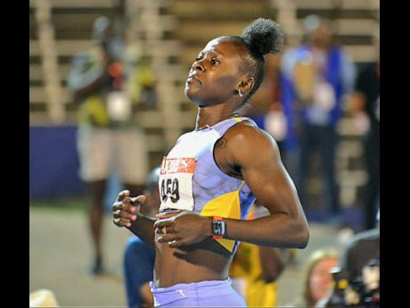 Shericka Jackson jogs through the tape after completing the sprint double at the JAAA/PUMA National Senior and Junior Championships inside the National Stadium this evening.
