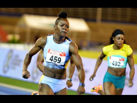 Shericka Jackson wins the women’s 100 metres final at the JAAA National Senior and Junior Championships last Friday night at the National Stadium clocking a world leading 10.65 seconds. At right is Elaine Thompson Herah who placed fifth in 11.06.  