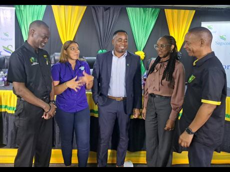 Jamaica Football Federation (JFF) General Secretary Dennis Chung (right) discussing the Reggae Girlz’ historic qualification for a second FIFA Women’s  World Cup with (from second right) Suzzette Ison (Sports Administrator, Ministry of Sports); Omar Br
