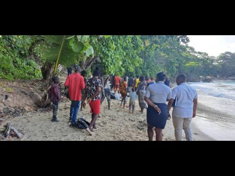 Haitians exiting the Boston beach in Portland, under the supervision of the police, en route to the Port Antonio Health Centre to undergo screening.