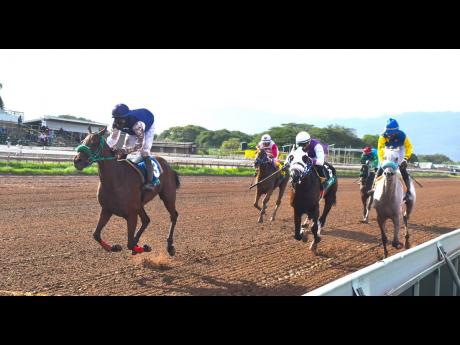 SUNSET SILHOUTTE  (left), ridden by Reyan Lewis, wins the Valbert Marlowe Memorial Cup over a mile at Caymanas Park on Saturday,  June 10, 2023.