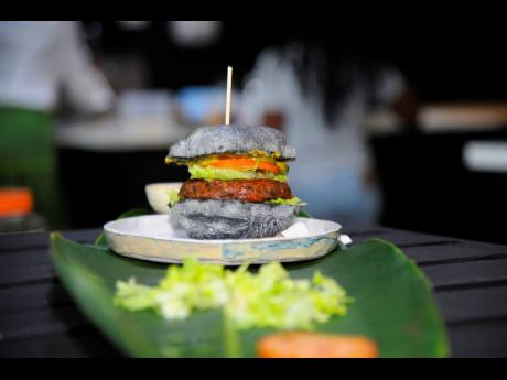 The rebranded black mamba burger is made from a lentil patty, seasonal leafy greens, tomatoes and pickles, with a spicy sauce packed in an activated-charcoal sourdough bun. 