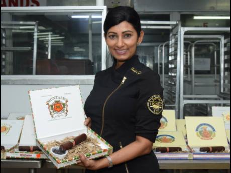 Bakery Treatz’s Michelle Sohan poses with the cigar box of chocolate. 