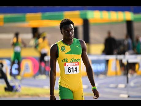 St Jago High School’s Demario Prince walks away a dejected man after being disqualified from the under-20 boys’ 110-metre final at the JAAA/PUMA National Senior and Junior Championships inside the National Stadium on Sunday.