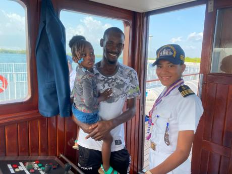 Euton Clarke (centre), captain of a tugboat that pulled in the Dominican Republic Navy training ship, ‘Juan Bautista Cambiaso’, takes part in a tour of the vessel with his daughter, Hailey Clarke (left), while sailor and tour guide, García Vargas, loo