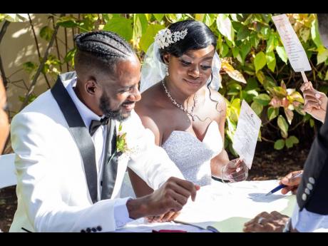  As the afternoon sun caressed their cool melanin skin, Jason and Kelley-Ann signed the official documents.
