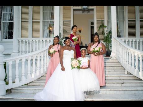 The bride, flanked by her bridesmaid Khadeen Grant (left) and flower girl Nashae Burrell (second right), is also joined by her maid of honour, Audra-Jade Morrison-Baker, and bridesmaid Kimberly Grant (right).