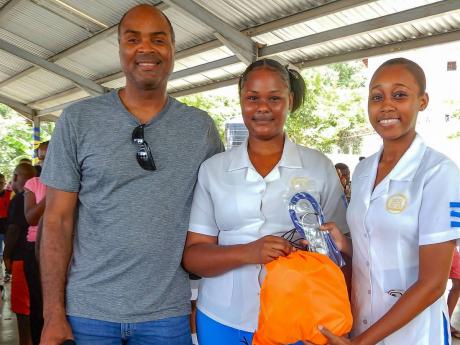  NAJ/Lasco Nursing Student of the Year 2022-23, La-Daniel Campbell of Brown’s Town Community College, (right) and fellow student, Kawana Janscen, with Ian Clough, after he presented them with medical equipment, including stethoscopes.