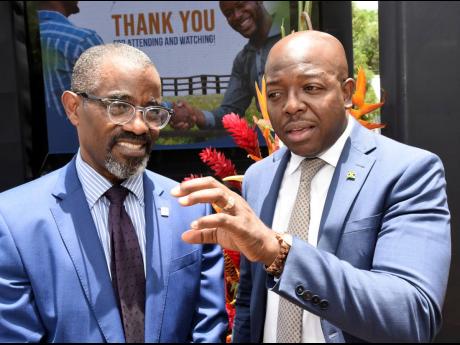 Pearnel Charles Jr (right), then-minister of agriculture and fisheries, thanks Anthony Shaw (left), managing director of the Development Bank of Jamaica (DBJ), for making over J$1 billion available to the agriculture sector where the intention was to focus
