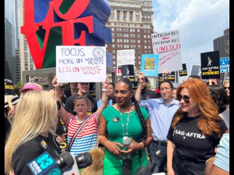 Actors Sheryl Lee Ralph (left) and Lisa Ann Walter, members of the cast of ‘Abbott Elementary’, participate in a rally in support of the actors and writers strikes at Love Park in Philadelphia on Thursday.
