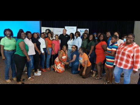 Health and Wellness Minister Dr Christopher Tufton (centre) poses for a group photo with 50 parents who were participating in a mental wellness parenting seminar at Jewel Grande Montego Bay Resort and Spa in Rose Hall, St James, yesterday.