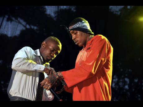 Donning a orange jumpsuit, a handcuffed Vybz Kartel was escorted on stage during Dancehall Night for Reggae Sumfest 2010.