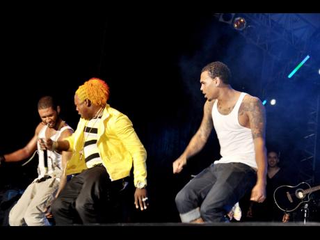 Usher (left) is joined on stage by Elephant Man (centre) and Chris Brown on the final night of the Reggae Sumfest 2010.