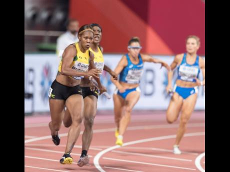 Natasha Morrison runs the anchor leg of the 4X100m relay following the baton exchange from third leg runner Jonielle Smith as they compete in the qualifiers at the 2019 IAAF World Athletics Championships held at the Khalifa International Stadium in Doha, Q