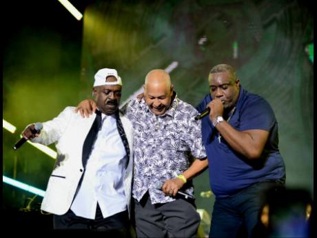 King Jammy (centre) is sandwiched by Admiral Bailey and Chaka Demus (left) during a special Reggae Sumfest tribute.