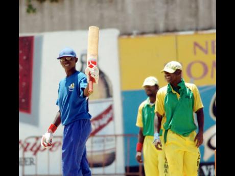 In this 2007 file picture, Barbados batsman Ricardo Manning raises his bat after reaching a half-century against Jamaica at the Melbourne Cricket Club grounds. 