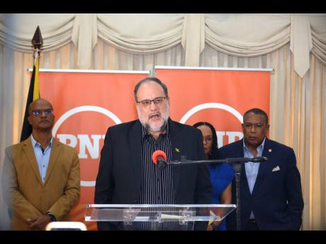 Opposition Leader Mark Golding addresses journalists during a press conference at the Office of the Leader of the Opposition in St Andrew yesterday. He is joined by (from left) Peter Bunting, leader of opposition business in the Senate and opposition spoke