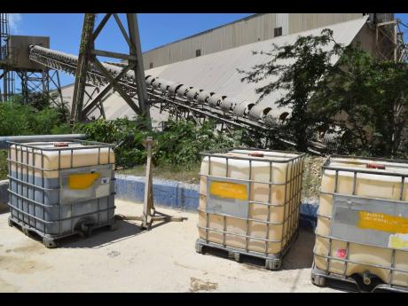 A set of industrial bulk containers filled with used oils ready to be repurposed as an alternative form of energy and fuel in the cement-making process.