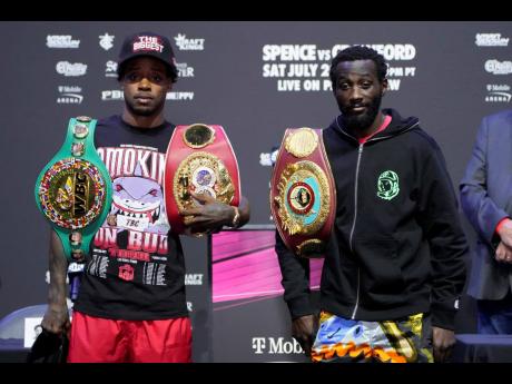Errol Spence Jr  (left) and Terence Crawford pose during a news conference on Thursday in Las Vegas. The two are scheduled to fight in an undisputed welterweight championship boxing match tonight in Las Vegas. 