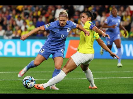 France's Eugenie Le Sommer (left) and Brazil's Rafaelle battle for the ball during the Women's World Cup Group F football match in Brisbane, Australia, today. France won 2-1.