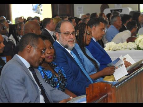 From left: Finance Minister Dr Nigel Clarke has a word with Sandra Golding, as her husband Opposition Leader Mark Golding looks on during the thanksgiving ceremony for Jill Stewart on Saturday. Also pictured are Juliet Holness and husband, Prime Minister A
