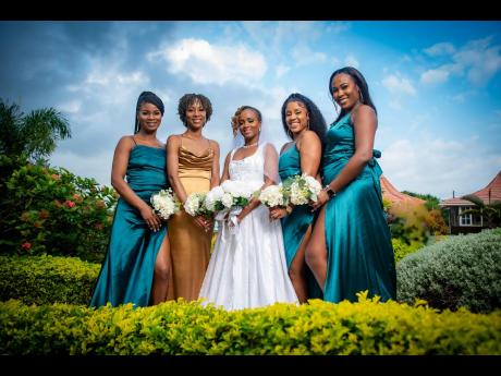 Celebrating the grand occasion with the bride are (from left) bridesmaid Sue-Ann Daley; maid of honour and sister of the bride, Janiel Thompson; and bridesmaids Sebukie Brown and Kimberly Morrison. 