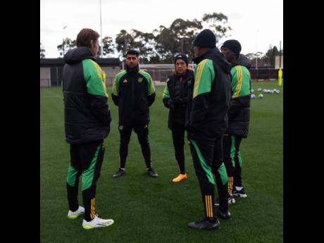 Reggae Girlz’ head coach Lorne Donaldson (second right), and assistant coach Xavier Gilbert (right) discuss tactics with performance coach Will Hitzelberger (left) and assistant coaches Ak Lakhani and Laurie Thomas during a training camp in Australia rec
