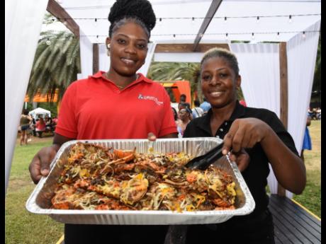 Gioni Green (left) and Christine Whyte of Junior’s Gourmet show off a fresh batch of lobster ready to be served from Chef Lobster Belly’s tent.