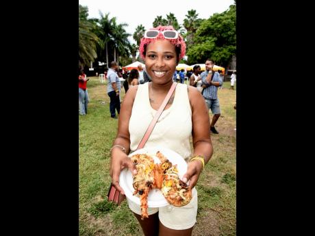 Shakera Virgo grabs not one, but two lobsters from Chef Lobster Belly’s pots during the festival.