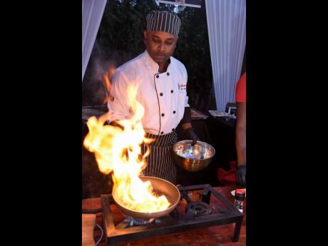 Did somebody say flambé? Chef Dennis Osbourne puts on a fiery show as he presents his culinary creations to the crowd.