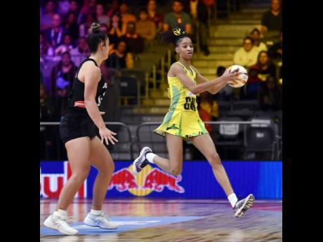 Sunshine Girls goal keeper Shamera Sterling (right) grabs onto a ball ahead of her New Zealand opponent during a Pool G second round Netball World Cup game at the Cape Town International Convention Centre in Cape Town, South Africa this morning.
